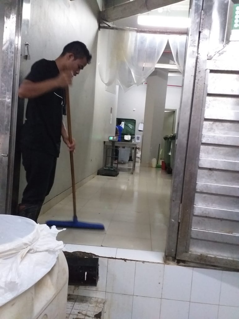 Image 39. Person mopping a tiled corridor in a recovery facility