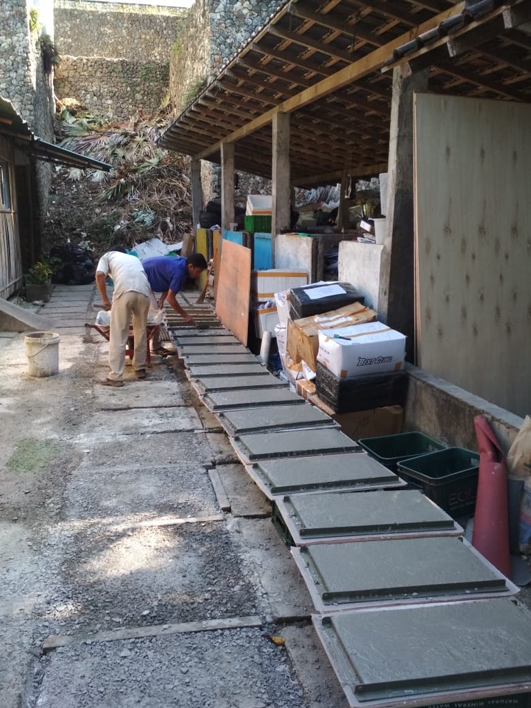 Image 29. Long outdoor row of freshly cast glass-concrete tiles curing under cover