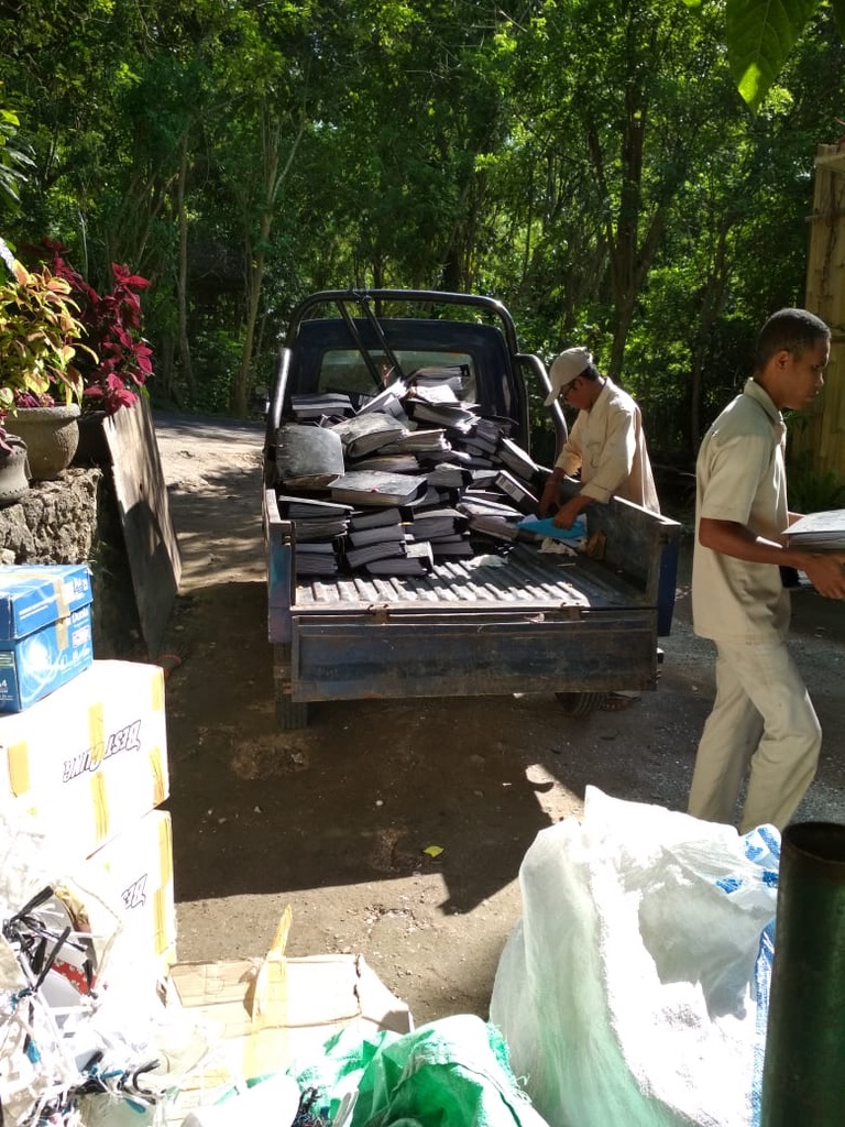 Image 30. Pickup truck loaded with stacks of glass-aggregate tiles