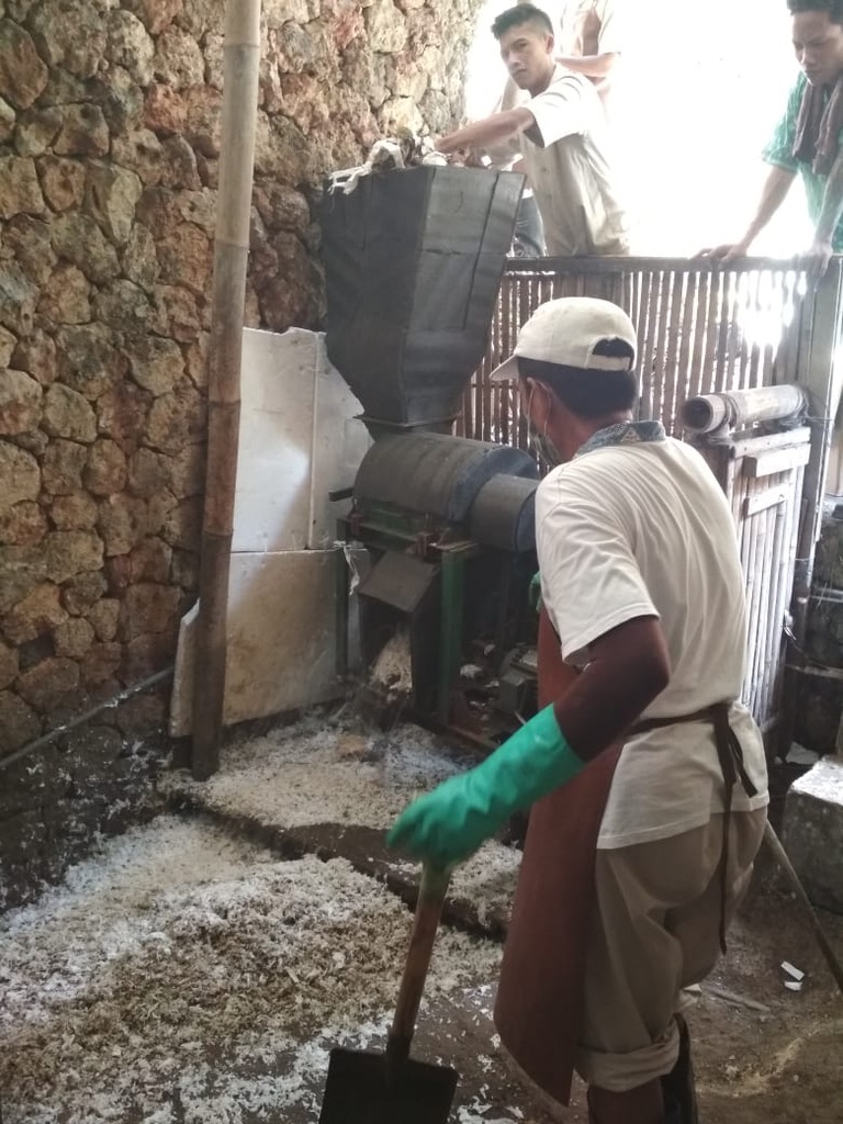 Image 32. Operators running a shredder with shredded plastic on the floor
